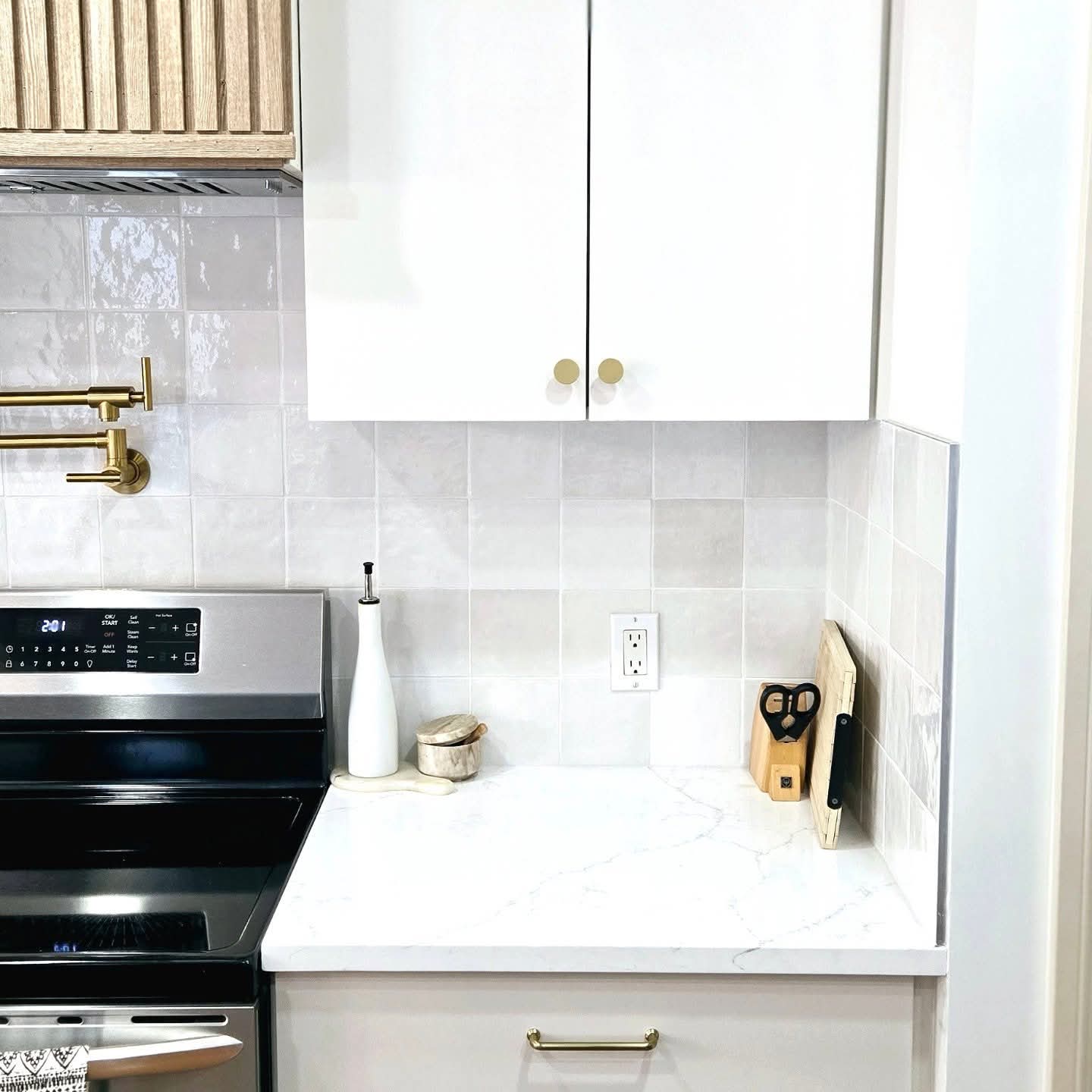 Sprayed white upper cabinets with tile backsplash in Marda Loop, Calgary Sprayed white upper cabinets with tile backsplash in Marda Loop, Calgary